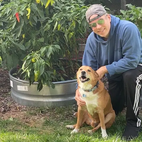 Troy with his dog in the garden