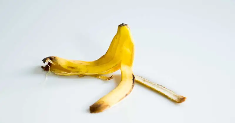 upside down yellow banana peel on white countertop