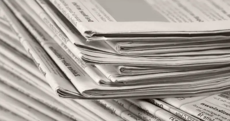closeup of large stack of black and white newspapers